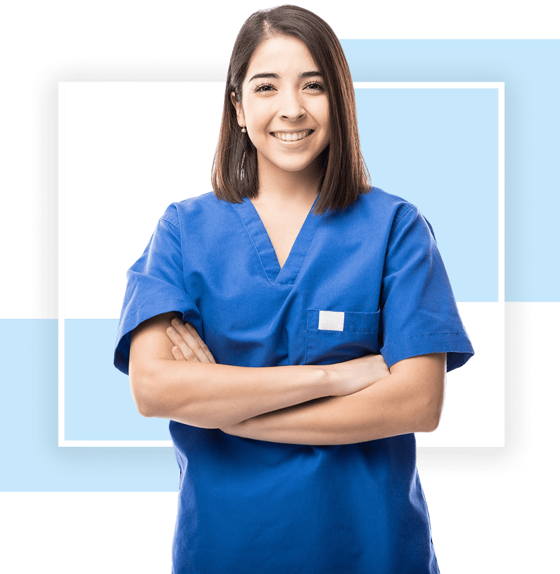 Smiling nurse in blue scrubs, arms crossed.
