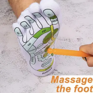 Hand drawing on foot reflexology chart with a pencil.