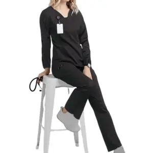 Woman in a black outfit sitting on a white stool.