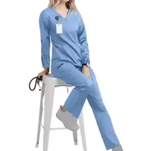 Woman in a blue casual loungewear set sitting on a stool.